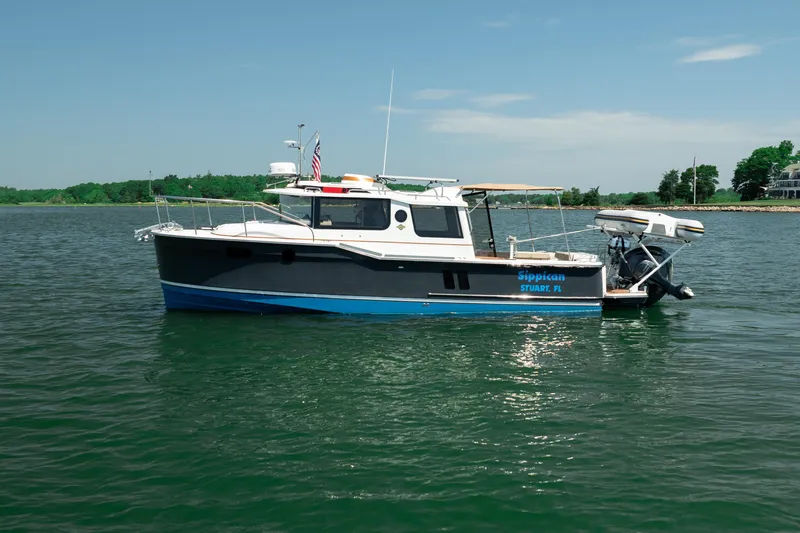 Slide: The Image of 2024 Ranger Tugs R-27 boat on calm water, featuring sleek design and modern amenities. - 9