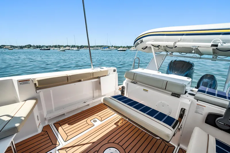 Slide: The Image of 2024 Ranger Tugs R-27 boat interior with seating and scenic water view. - 26
