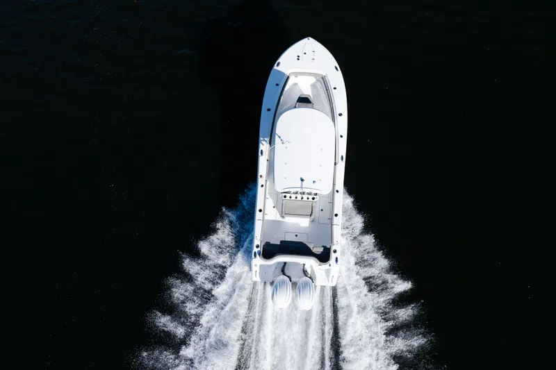Slide: The Image of Aerial view of 2026 Sea Hunt Ultra 275 Coffin Box boat speeding on water. - 0