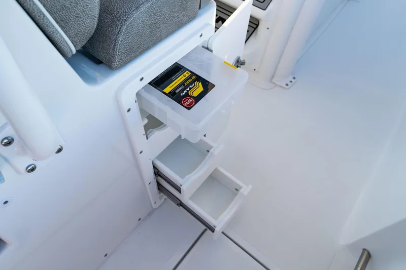 Slide: The Image of Storage compartment on 2026 Sea Hunt Ultra 275 Coffin Box boat, featuring organized drawers. - 32