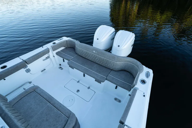 Slide: The Image of 2026 Sea Hunt Ultra 275 Coffin Box boat interior with dual engines on calm water. - 20