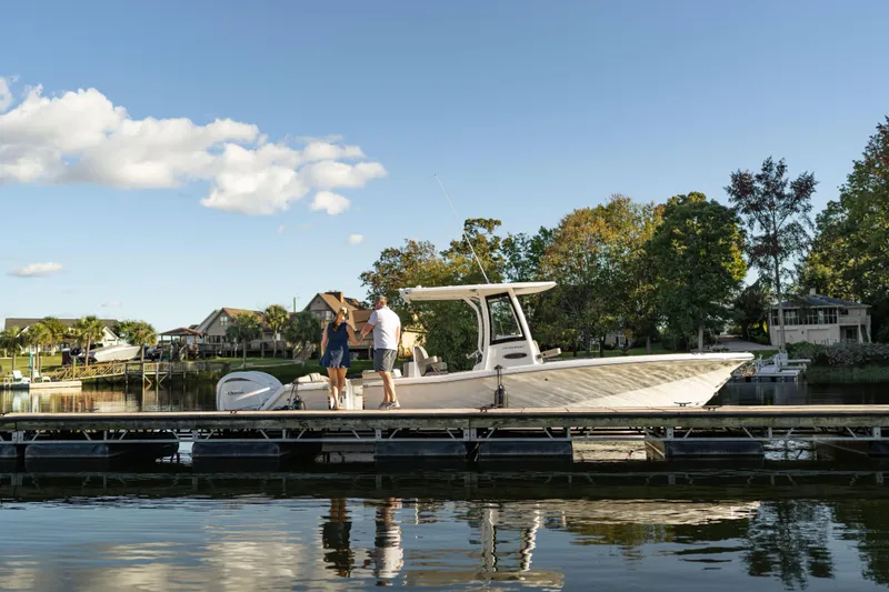 Slide: The Image of 2026 Sea Hunt Ultra 275 Coffin Box boat docked on a sunny day. - 44