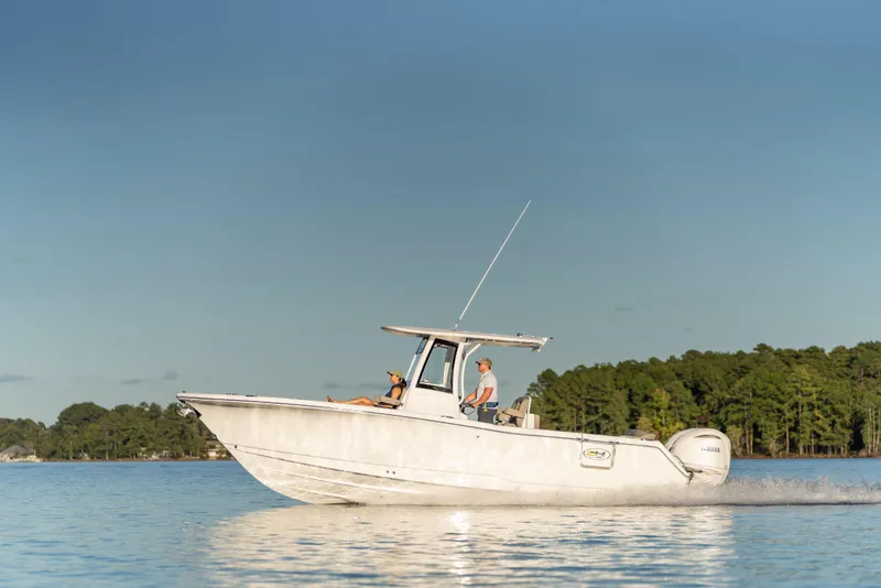 Slide: The Image of 2026 Sea Hunt Ultra 275 Coffin Box boat cruising on a calm lake. - 11