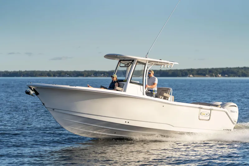 The Image of 2026 Sea Hunt Ultra 275 Coffin Box cruising on a calm lake. - 2