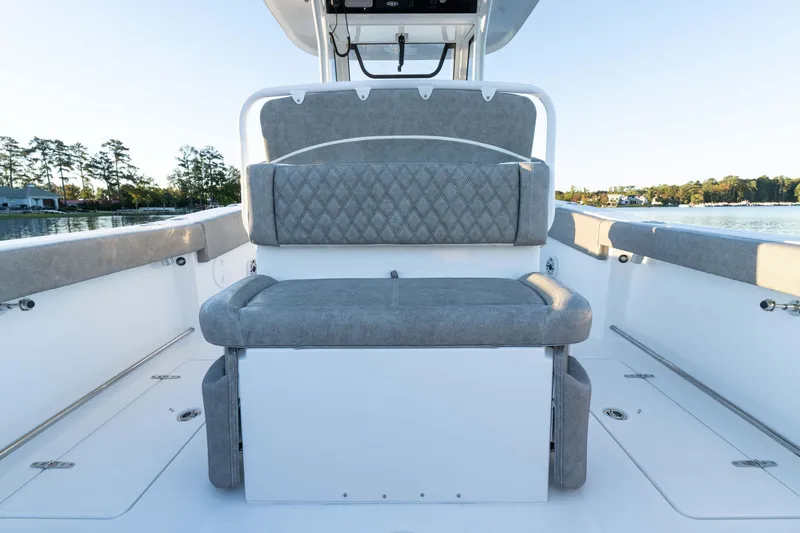 Slide: The Image of 2026 Sea Hunt Ultra 275 Coffin Box boat interior with cushioned seating and scenic water view. - 23