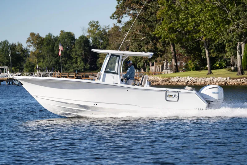 Slide: The Image of 2026 Sea Hunt Ultra 275 Coffin Box boat cruising on a scenic lake. - 39