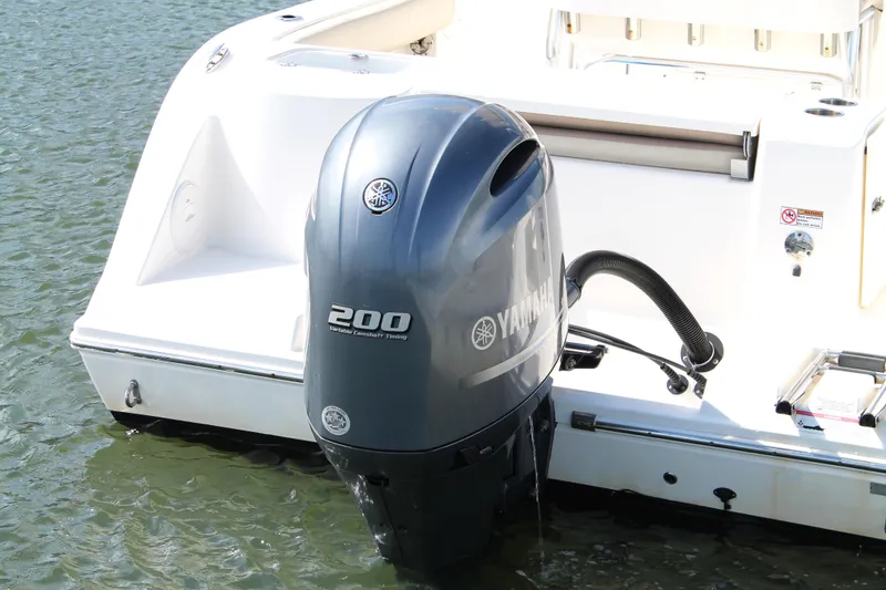 Slide: The Image of 2018 Cobia 220 Center Console with Yamaha 200 outboard engine on water. - 10
