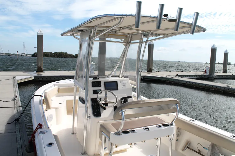 Slide: The Image of 2018 Cobia 220 Center Console boat docked at marina with ocean view. - 13