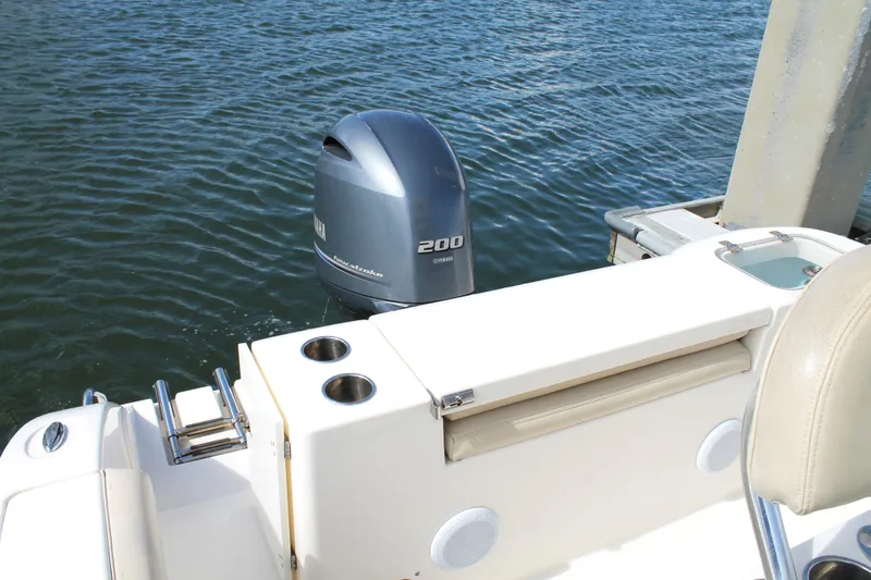 Slide: The Image of 2018 Cobia 220 Center Console boat with Yamaha 200 outboard motor on water. - 18