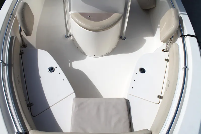 Slide: The Image of 2018 Cobia 220 Center Console boat interior with seating and storage compartments. - 25