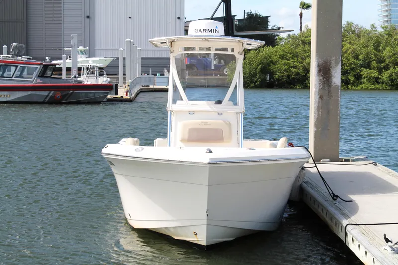 Slide: The Image of 2018 Cobia 220 Center Console boat docked at marina with Garmin equipment. - 5