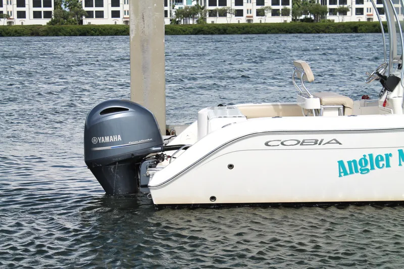 Slide: The Image of 2018 Cobia 220 Center Console boat with Yamaha outboard motor on water. - 8
