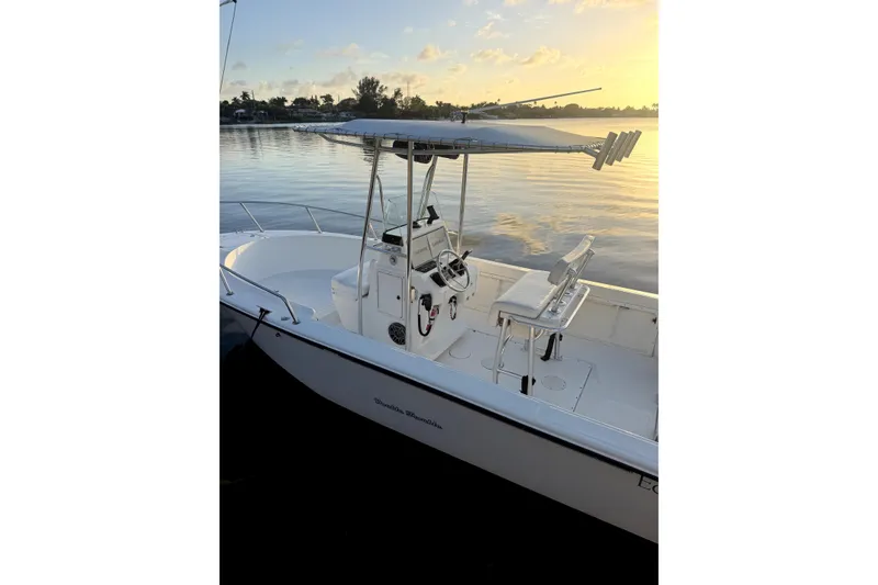 Slide: The Image of 1999 Edgewater 200CC boat at sunset on calm water. - 10