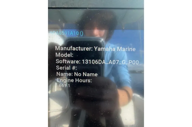 Slide: The Image of Reflection on boat display showing Yamaha Marine engine details and software information. - 2