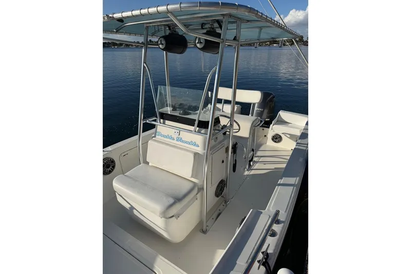 Slide: The Image of 1999 Edgewater 200CC boat with seating and console on calm water. - 6