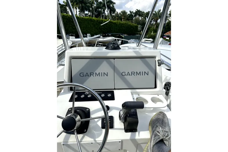 Slide: The Image of 1999 Edgewater 200CC boat dashboard with Garmin navigation system and steering wheel. - 7