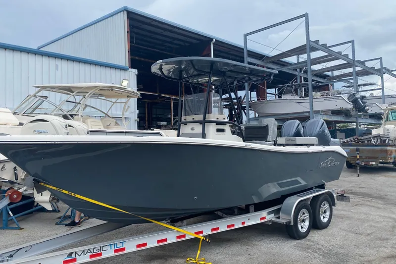 Slide: The Image of 2026 Sea Chaser 24 HFC boat on trailer in marina storage area. - 1