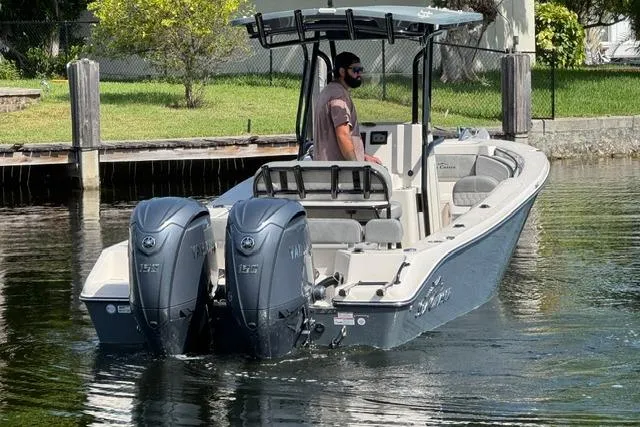 Slide: The Image of 2026 Sea Chaser 24 HFC boat with dual Yamaha engines on a calm waterway. - 4