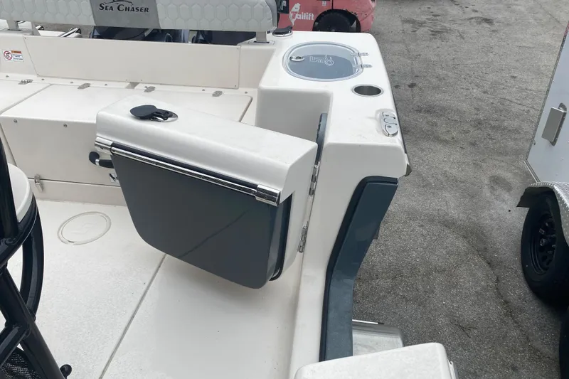 Slide: The Image of 2026 Sea Chaser 24 HFC boat deck with storage compartment and seating. - 9