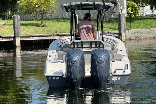 Slide: The Image of 2026 Sea Chaser 24 HFC boat with dual engines navigating a calm waterway. - 3
