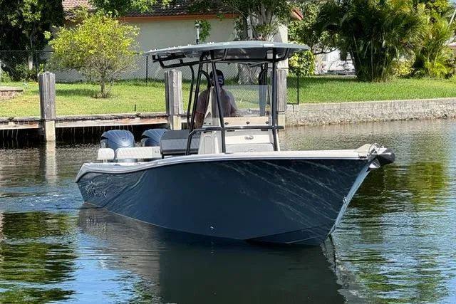 Slide: The Image of 2026 Sea Chaser 24 HFC boat cruising on a calm waterway. - 7