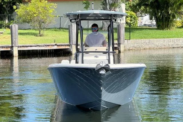 Slide: The Image of 2026 Sea Chaser 24 HFC boat on calm water, front view. - 8