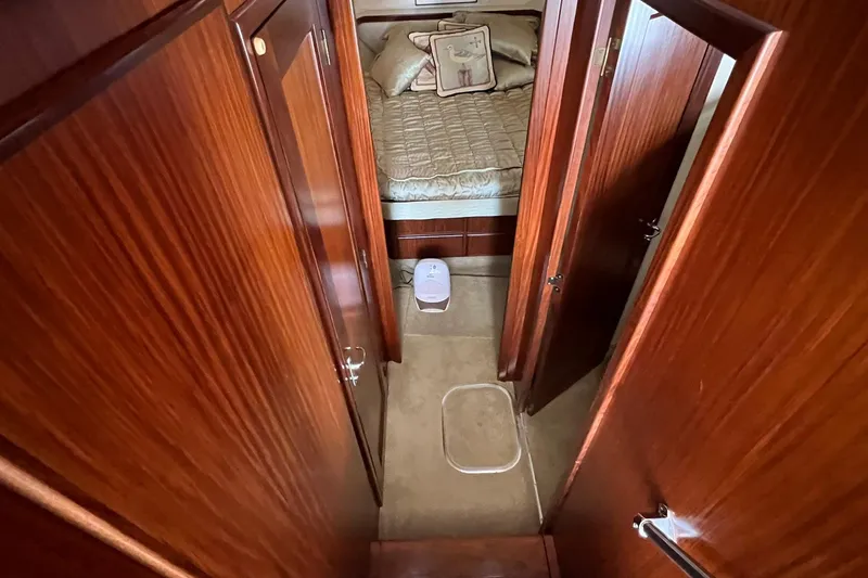 Slide: The Image of Interior of 1990 Hatteras 41 Convertible yacht with wood paneling and cozy bedroom. - 10