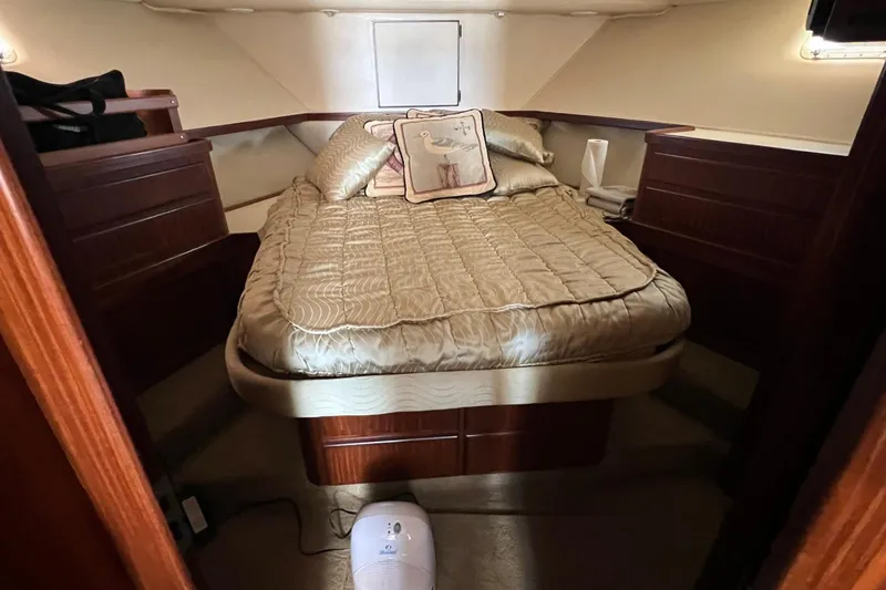 Slide: The Image of Cozy cabin interior of 1990 Hatteras 41 Convertible yacht with elegant bedding. - 12