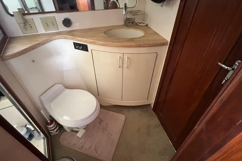 Slide: The Image of Bathroom interior of 1990 Hatteras 41 Convertible yacht, featuring sink and toilet. - 13