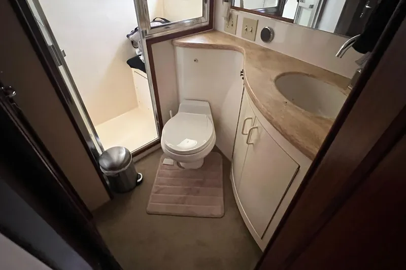Slide: The Image of Bathroom interior of 1990 Hatteras 41 Convertible yacht, featuring toilet and sink. - 14