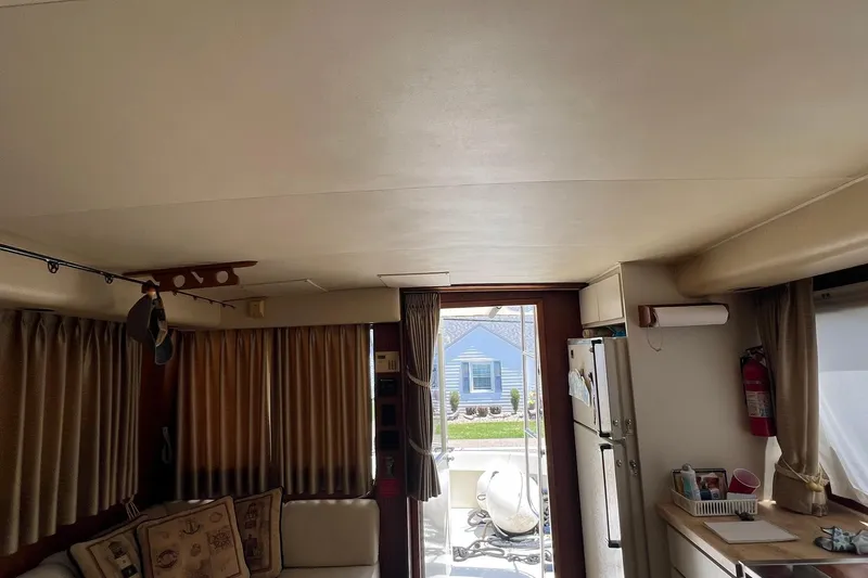 Slide: The Image of Interior of 1990 Hatteras 41 Convertible yacht with cozy seating and kitchen area. - 17