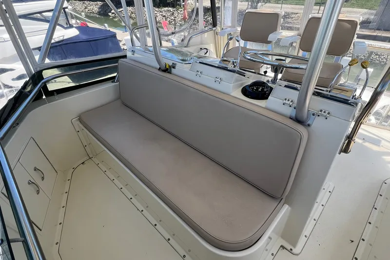Slide: The Image of 1990 Hatteras 41 Convertible boat interior with cushioned seating and helm station. - 6