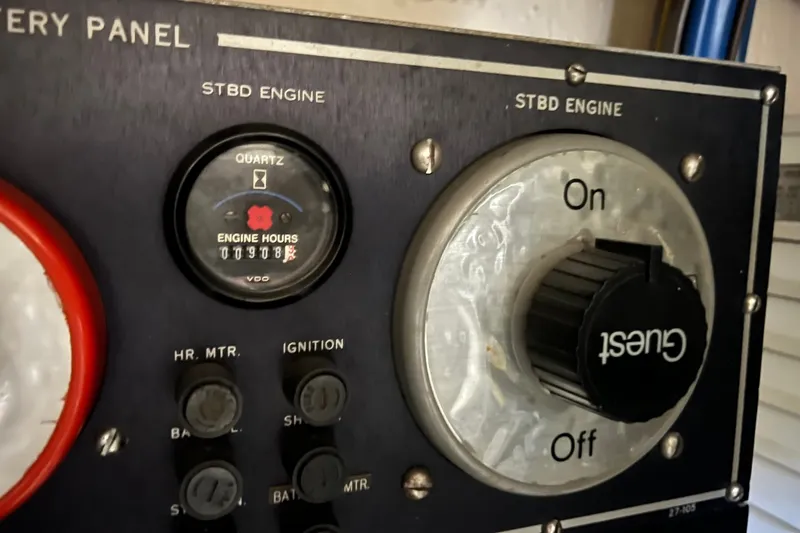 Slide: The Image of Control panel of a 1990 Hatteras 41 Convertible boat showing engine hours and switches. - 26