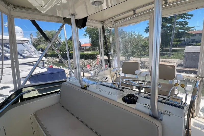Slide: The Image of Interior view of 1990 Hatteras 41 Convertible yacht cockpit with seating and controls. - 5
