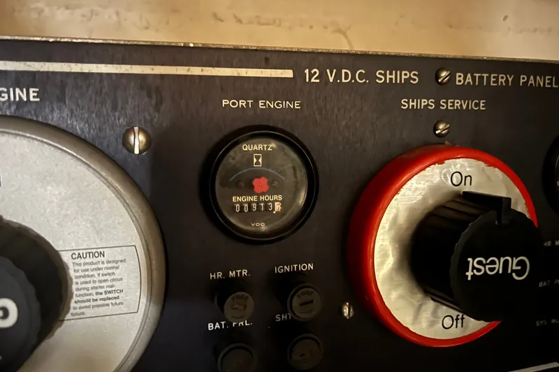 Slide: The Image of Control panel of a 1990 Hatteras 41 Convertible boat, showing engine hours and switches. - 27