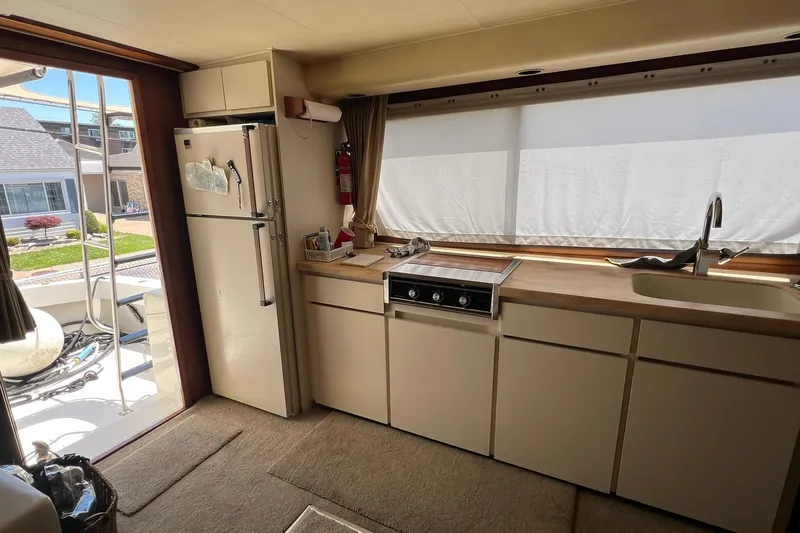Slide: The Image of Interior of 1990 Hatteras 41 Convertible yacht kitchen with appliances and window view. - 8