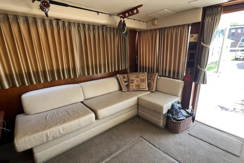Slide: The Image of Luxurious interior of 1990 Hatteras 41 Convertible yacht with cream sofa and decorative pillows. - 9
