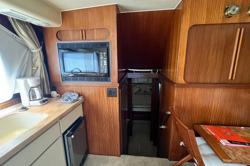 Slide: The Image of Interior of 1990 Hatteras 41 Convertible yacht with kitchenette and microwave. - 23