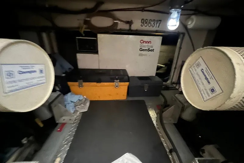 Slide: The Image of Engine room of 1990 Hatteras 41 Convertible with Onan generator and tools. - 31