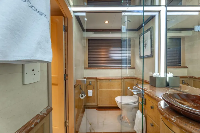 Slide: The Image of Luxurious yacht bathroom with glass shower, wooden accents, and modern fixtures, Trinity Yachts 1998 model. - 29