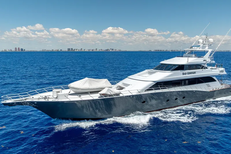 The Image of Luxurious 1998 Trinity Yachts model cruising on open blue sea under clear skies. - 1