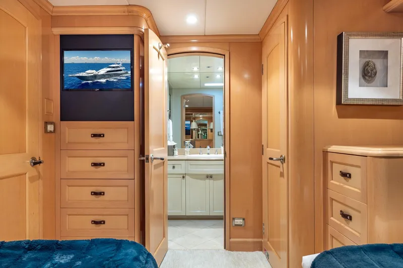 Slide: The Image of Luxurious 1998 Trinity Yachts interior with wooden cabinetry and ensuite bathroom. - 37