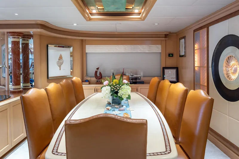 Slide: The Image of Luxurious dining area on a 1998 Trinity Yachts model, featuring elegant decor and leather seating. - 20