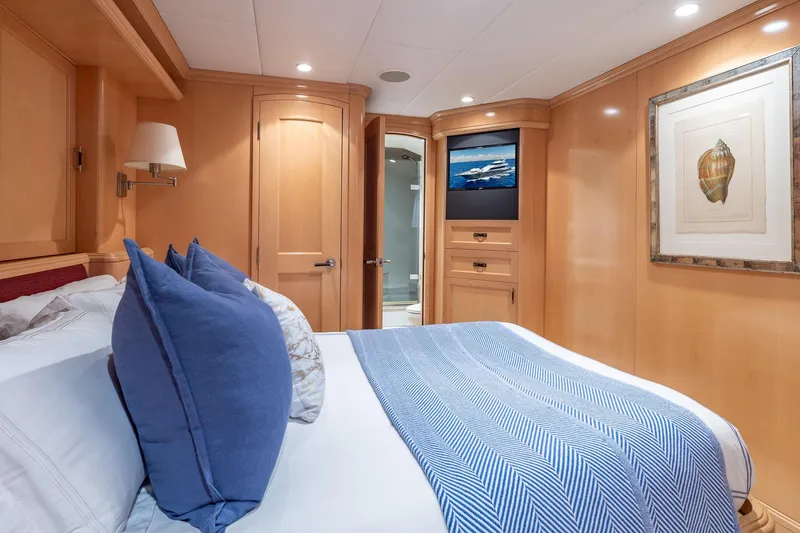 Slide: The Image of Luxurious bedroom interior on a 1998 Trinity Yachts model, featuring elegant wood paneling and cozy bedding. - 40