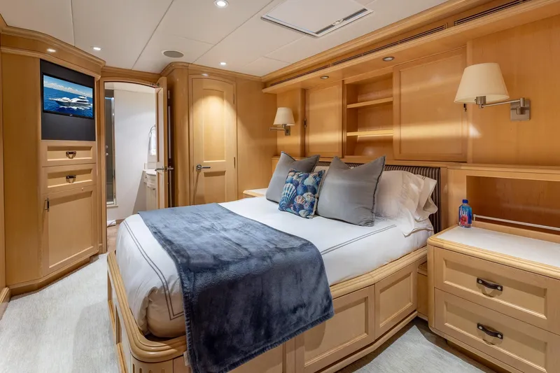 Slide: The Image of Luxurious 1998 Trinity Yachts bedroom with elegant wood paneling and cozy bedding. - 43