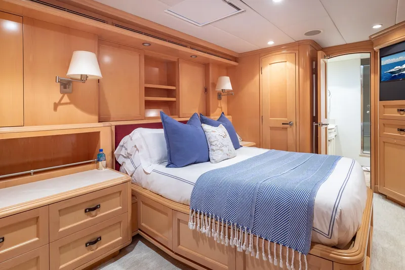Slide: The Image of Luxurious 1998 Trinity Yachts bedroom with elegant wood paneling and cozy bedding. - 39