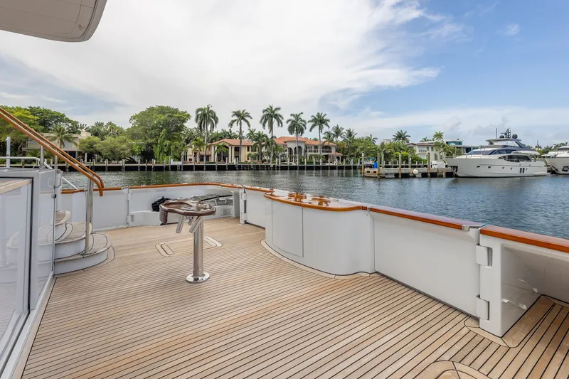Slide: The Image of Spacious deck of 1998 Trinity Yachts overlooking serene waterfront and luxury homes. - 8