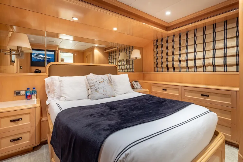 Slide: The Image of Luxurious 1998 Trinity Yachts bedroom with elegant wood paneling and cozy bedding. - 31