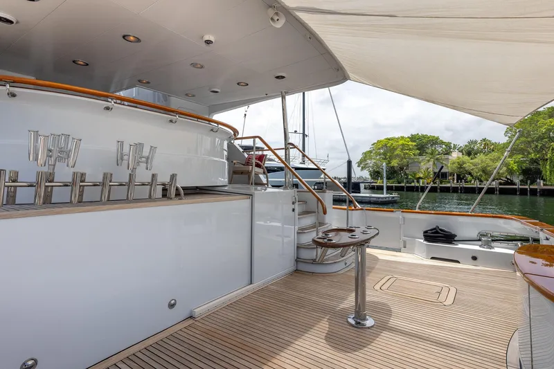 Slide: The Image of Luxurious 1998 Trinity Yachts deck with bar taps and scenic waterfront view. - 10