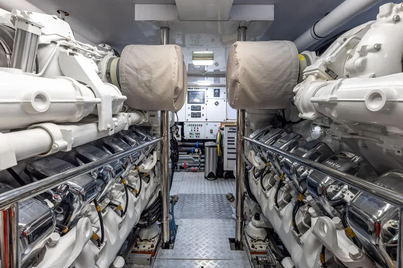 Slide: The Image of Engine room of a 1998 Trinity Yachts model, showcasing dual engines and control panels. - 57